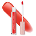 Clock Out ColourPop Ultra Matte Lip liquid lipstick stands open, doe-foot wand beside the clear tube as a vivid orange-red swatch streaks behind; peach cap with white stars and silver accents on a clean white background.