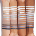 Cloud 9 ColourPop Shadow Palette swatches line three skin tones, showcasing 12 cool-toned mattes and shimmers - from crisp ivory and taupe to icy blue, silver, lilac, and deep navy - each shade labeled (Droplets to Stormy Skies) for easy comparison.