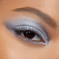 Shimmering silver-blue smokey eye applied with Cloud 9 ColourPop Shadow Palette, featuring a metallic lid, diffused crease, bright inner-corner highlight, and defined lashes in a tight close-up of one eye.