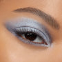 Shimmering silver-blue smokey eye applied with Cloud 9 ColourPop Shadow Palette, featuring a metallic lid, diffused crease, bright inner-corner highlight, and defined lashes in a tight close-up of one eye.