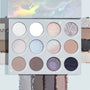 Cloud 9 ColourPop Shadow Palette opens to 12 cool‑toned shades - silvers, taupes, icy blues, and mauves - in matte, shimmer, and glitter finishes, with swatches along the edges and bottom on a pale blue background showing payoff and texture.
