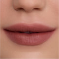 Close-up of smooth, full lips wearing Cloudy Hour Cloud Whip Blurring Liquid Lipstick in a soft mauve nude shade, showing a velvety, blurred-matte finish against natural, even-toned skin for a comfortable everyday lip look.