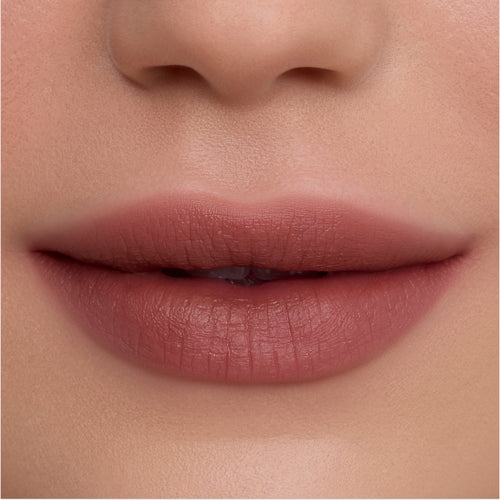 Close-up of smooth, full lips wearing Cloudy Hour Cloud Whip Blurring Liquid Lipstick in a soft mauve nude shade, showing a velvety, blurred-matte finish against natural, even-toned skin for a comfortable everyday lip look.