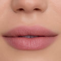 Close-up of smooth, softly blurred lips wearing Floating on Air Cloud Whip Blurring Liquid Lipstick, showing a velvety pink-nude finish and airbrushed texture against natural, even-toned skin, highlighting the lightweight Cloud Whip formula.