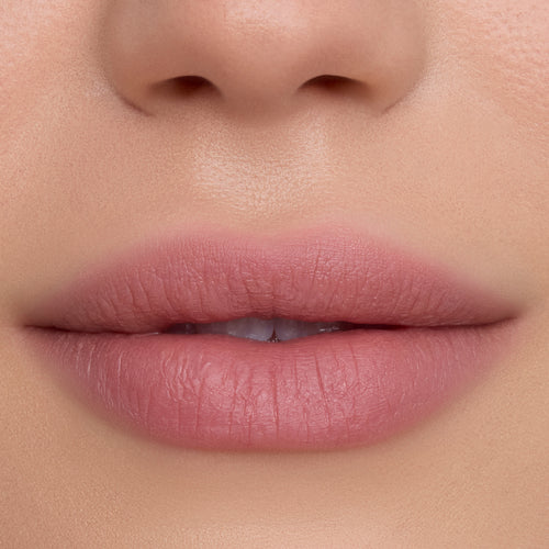 Close-up of smooth, softly blurred lips wearing Floating on Air Cloud Whip Blurring Liquid Lipstick, showing a velvety pink-nude finish and airbrushed texture against natural, even-toned skin, highlighting the lightweight Cloud Whip formula.