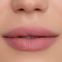 Close-up of smooth, softly blurred lips wearing Floating on Air Cloud Whip Blurring Liquid Lipstick, showing a velvety pink-nude finish and airbrushed texture against natural, even-toned skin, highlighting the lightweight Cloud Whip formula.
