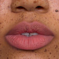 Close-up of freckled lips wearing Fluffing Cute Cloud Whip Blurring Liquid Lipstick in a soft matte pink, showing smooth, blurred edges and velvety Cloud Whip texture on medium skin tone for an airbrushed lip look.