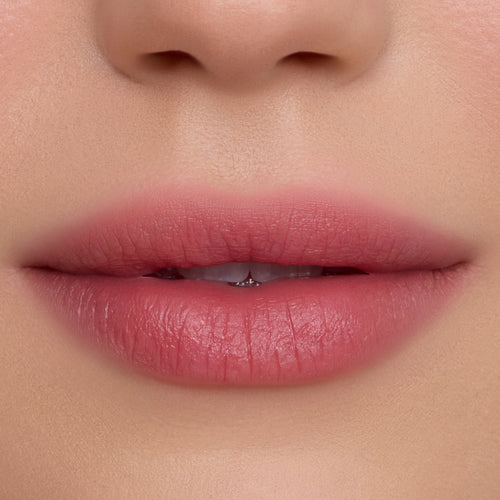 Close-up of soft, natural pink lips wearing Fluffing Cute Cloud Whip Blurring Liquid Lipstick, showing a smooth, blurred matte finish against even, fair skin, highlighting the Cloud Whip formula’s airy texture and diffused color payoff.