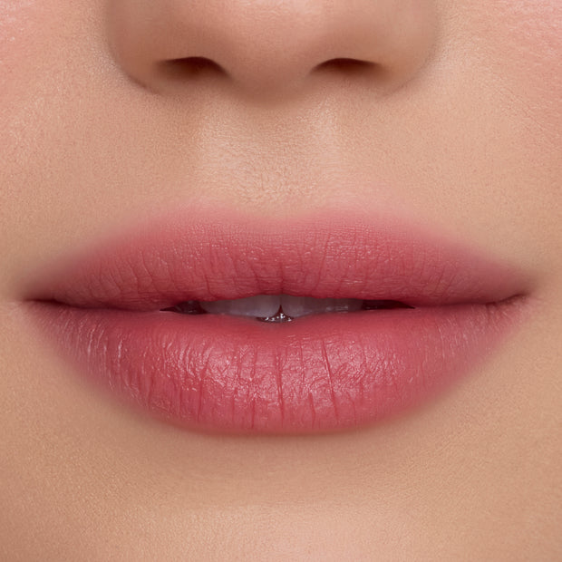 Close-up of soft, natural pink lips wearing Fluffing Cute Cloud Whip Blurring Liquid Lipstick, showing a smooth, blurred matte finish against even, fair skin, highlighting the Cloud Whip formula’s airy texture and diffused color payoff.