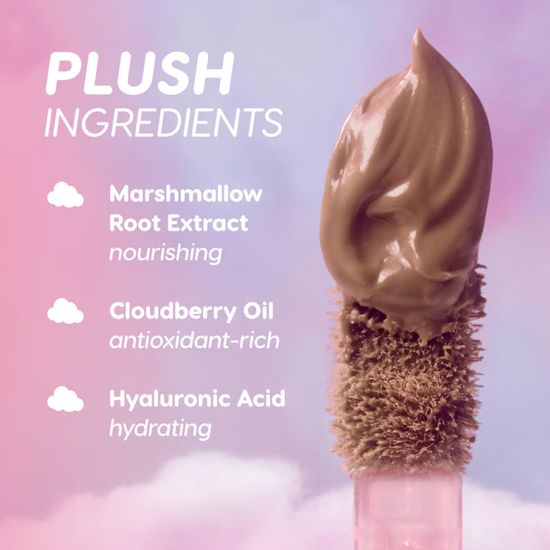 Cloud Whip Blurring Liquid Lipstick in shade In a Haze shown on a plush applicator against a dreamy pink and purple cloud background, highlighting key ingredients marshmallow root extract, cloudberry oil, and hyaluronic acid.