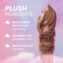 Cloud Whip Blurring Liquid Lipstick in shade In a Haze shown on a plush applicator against a dreamy pink and purple cloud background, highlighting key ingredients marshmallow root extract, cloudberry oil, and hyaluronic acid.