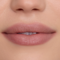 Close-up of a model’s lips wearing In a Haze Cloud Whip Blurring Liquid Lipstick, showing a soft matte nude-pink finish with smooth, blurred edges against natural, even-toned skin, highlighting the lightweight Cloud Whip texture.