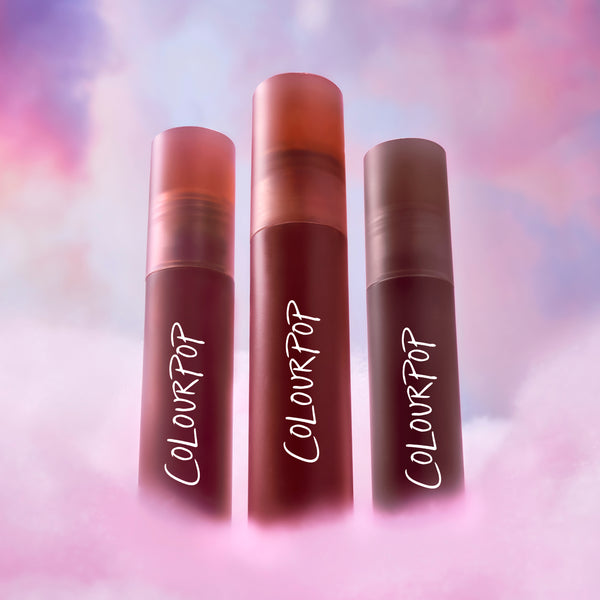 ColourPop Cloud Crushin lip trio standing upright in a dreamy pink and purple cloud backdrop, showcasing three blurring liquid lipsticks as a makeup Value Sets option for soft-focus, cloud-like lip color.