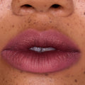 Full, close-up lips wearing Mocha Plum Lip Ombre Duo, showing a soft matte plum gradient with subtle blurring effect on freckled skin, highlighting the rich color payoff of this CloudWhip lipstick from the Mocha Plum Value Sets collection.