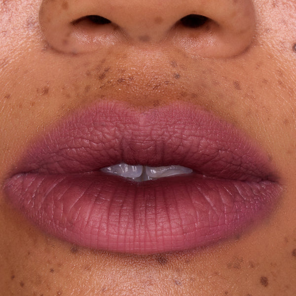 Full, close-up lips wearing Mocha Plum Lip Ombre Duo, showing a soft matte plum gradient with subtle blurring effect on freckled skin, highlighting the rich color payoff of this CloudWhip lipstick from the Mocha Plum Value Sets collection.