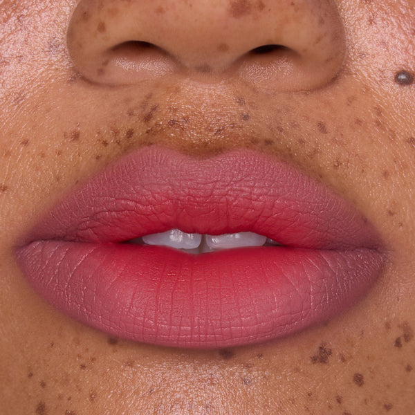 Close-up of full lips wearing Sunset Smooch Lip Ombre Duo, showing a smooth pink-to-coral gradient with a soft-matte blurred finish, ideal for beauty lovers shopping lip value sets in the US.