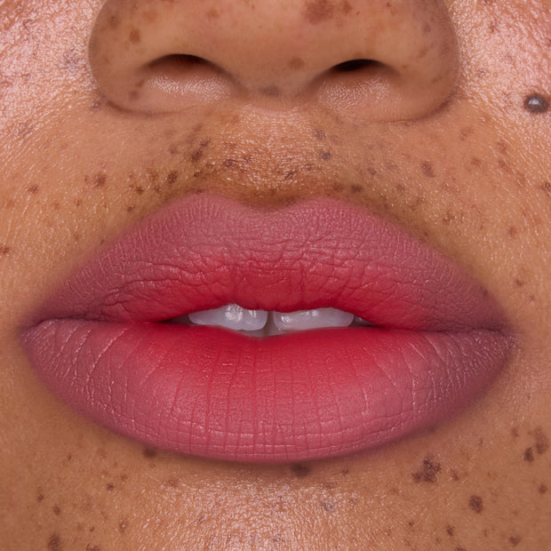 Close-up of full lips wearing Sunset Smooch Lip Ombre Duo, showing a smooth pink-to-coral gradient with a soft-matte blurred finish, ideal for beauty lovers shopping lip value sets in the US.