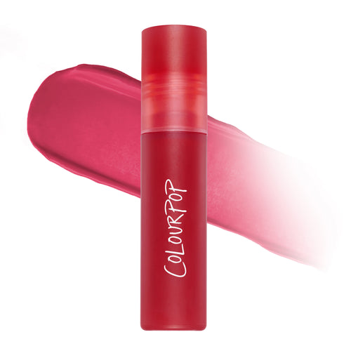 ColourPop Mile High Cloud Whip Blurring Liquid Lipstick standing upright with a blurred swatch of vibrant rosy-red color behind it on a white background, highlighting the soft-matte Cloud Whip finish for lips.
