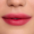 Close-up of soft, blurred lips wearing Mile High Cloud Whip Blurring Liquid Lipstick, showing a smooth gradient of rosy pink color with a velvety, airbrushed finish against flawless skin.