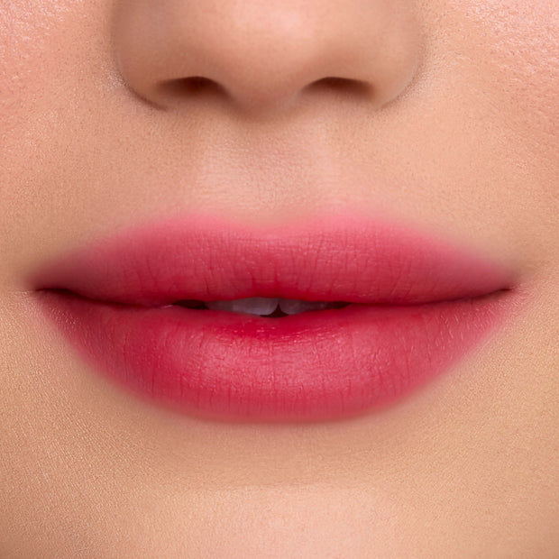 Close-up of soft, blurred lips wearing Mile High Cloud Whip Blurring Liquid Lipstick, showing a smooth gradient of rosy pink color with a velvety, airbrushed finish against flawless skin.