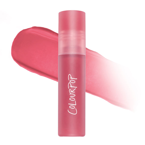 On Cloud 9 Cloud Whip Blurring Liquid Lipstick tube standing upright over a swatch of soft rosy pink color, showing its airy Cloud Whip formula and blurred matte finish on a clean white background for US beauty shoppers.