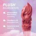 Cloud Whip On Cloud 9 Blurring Liquid Lipstick applicator swirls rich mauve formula against a pink and purple sky backdrop, highlighting plush ingredients marshmallow root extract, cloudberry oil, and hyaluronic acid for nourishing, hydrating color.