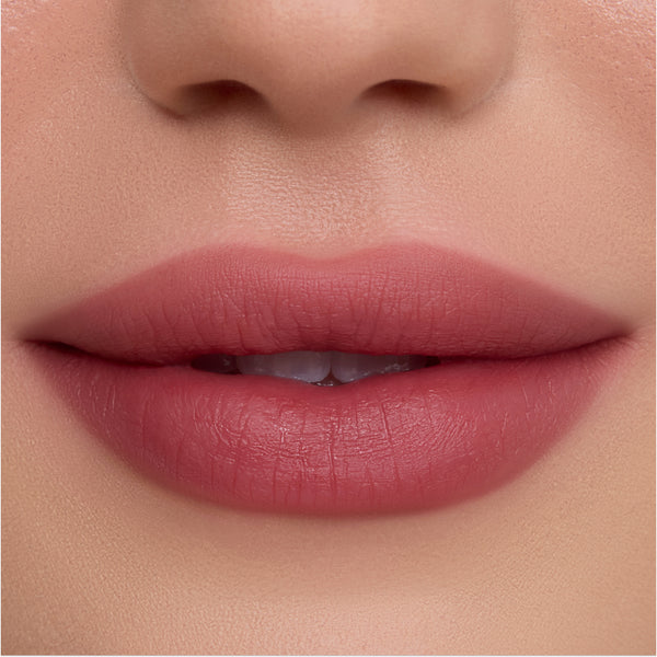 Close-up of smooth, full lips wearing Pretty Aura Cloud Whip Blurring Liquid Lipstick in a soft rosy mauve shade, showing velvety, blurred-matte finish and seamless color payoff against flawless skin.