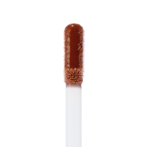 Doe-foot applicator swatched with Coffee Break, a warm coffee-brown Ultra Glossy Lip, showing high-shine, smooth texture and precise tip; ColourPop Ultra Glossy Lip wand isolated on a white background.