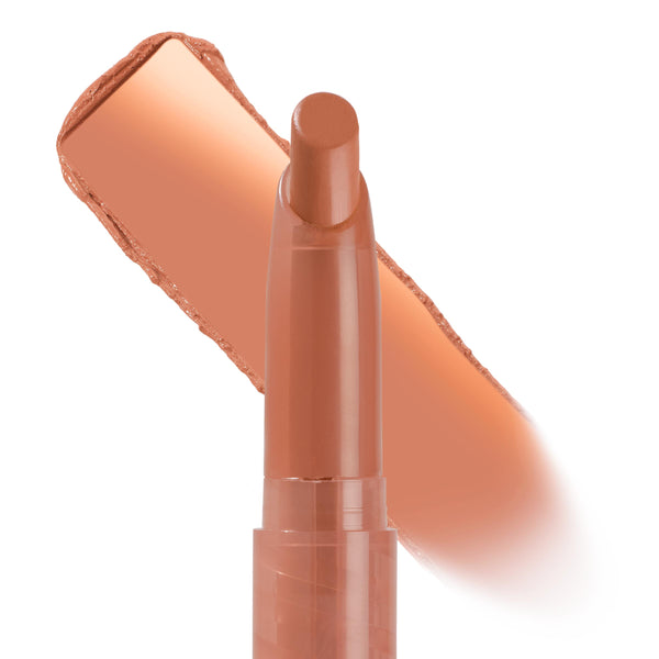 ColourPop Lippie Stix Cookie uncapped with bullet raised, a warm peachy nude swatch behind the tube on a white background, showcasing creamy color payoff and a neutral everyday lip shade.