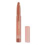 ColourPop Lippie Stix in Cookie extends from a translucent peach twist-up tube, uncapped with the cap beside it, revealing a warm nude-brown angled bullet; slim packaging with white logo on a clean white background.