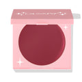 ColourPop Coyote cream blush compact sits half-open, revealing a deep berry pan in a pink square case with white star accents and ColourPop logo; matte cream formula for cheeks; ColourPop Cream Blush on a white background.