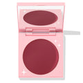 Coyote ColourPop Cream Blush compact sits open, revealing a large pan of deep berry-rose cream in a pink mirrored case with white star accents, photographed on a white background.