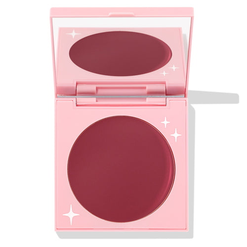 Coyote ColourPop Cream Blush compact sits open, revealing a large pan of deep berry-rose cream in a pink mirrored case with white star accents, photographed on a white background.