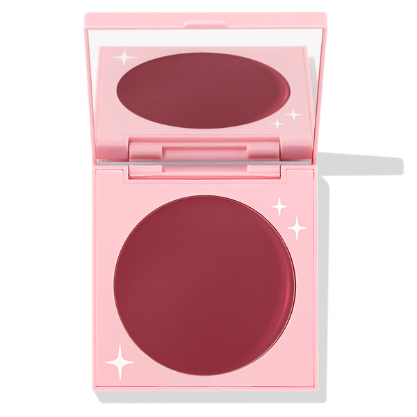 Coyote ColourPop Cream Blush compact sits open, revealing a large pan of deep berry-rose cream in a pink mirrored case with white star accents, photographed on a white background.