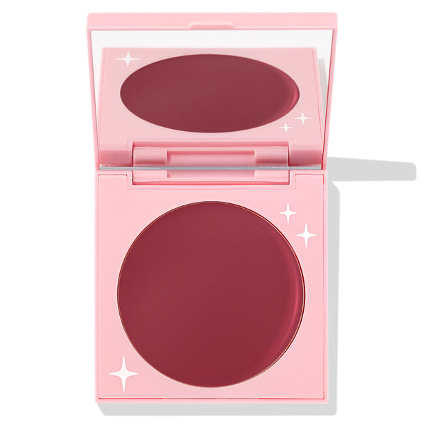 Coyote ColourPop Cream Blush compact sits open, revealing a large pan of deep berry-rose cream in a pink mirrored case with white star accents, photographed on a white background.