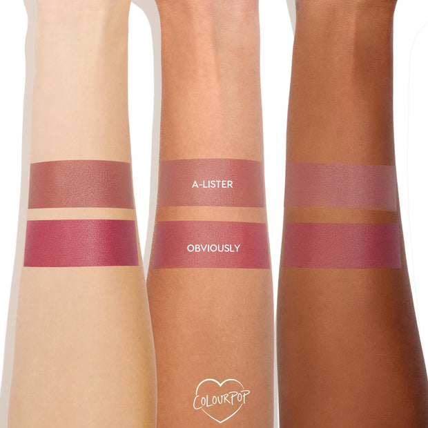 ColourPop Cream Blush in A-Lister swatched as the top stripe on three arms from fair to deep, showing a soft mauve‑pink sheen; the lower stripe shows the deeper rosy shade Obviously for comparison.