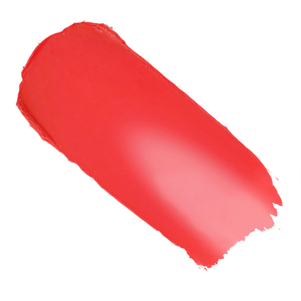 ElectroBall cream blush swatch streaked across white, a vivid electric coral-red with a soft satin sheen and feathered edges, showcasing the creamy, buildable payoff of ColourPop Cream Blush.