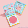 Metronome ColourPop Cream Blush compact opens to reveal a dewy rosy pink pan, shown beside its Pokémon x ColourPop packaging with a Clefairy window and character art, styled on a pastel pink background.