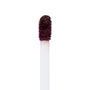 Doe-foot applicator coated in deep berry plum pigment, showing the saturated, velvety finish of ColourPop Ultra Matte Lip in Currant Mood, captured in a close-up macro against a clean white background.