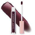 ColourPop Ultra Matte Lip in Currant Mood, a deep plum-burgundy liquid lipstick, stands with cap off as the doe-foot applicator rests beside it; clear tube with white logo and blush-pink starry cap, with a bold matte swatch behind on white.