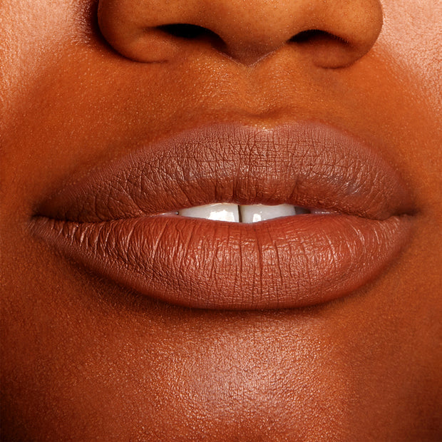 Lips wearing BFF3 ColourPop Lippie Pencil, lining and filling the mouth in a warm brown nude shade with a smooth, non-glossy finish; tight close-up swatch on lips highlighting precise color payoff and definition.