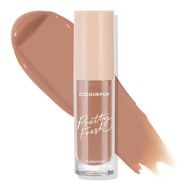 ColourPop Pretty Fresh Creamy Concealer in Dark 153 C stands upright with a beige cap, showcasing its hyaluronic formula and warm deep tan shade, as two large swatches streak behind on a white background.