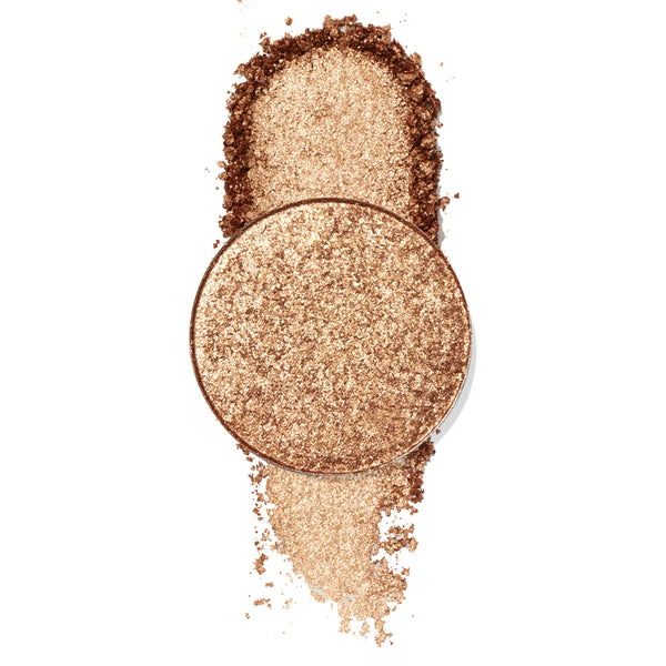 Round Diego ColourPop Pressed Powder Shadow pan in warm metallic gold‑bronze on a white backdrop, with crushed pigment swatched above and below to show high‑shine shimmer and fine sparkle.