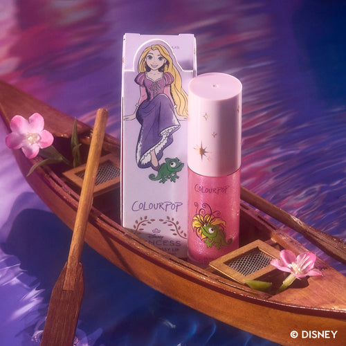 ColourPop Courageous Rapunzel Ultra Glossy Lip from the Disney Princess collection standing beside its illustrated Rapunzel box on a wooden boat with pink flowers floating on shimmering purple water.