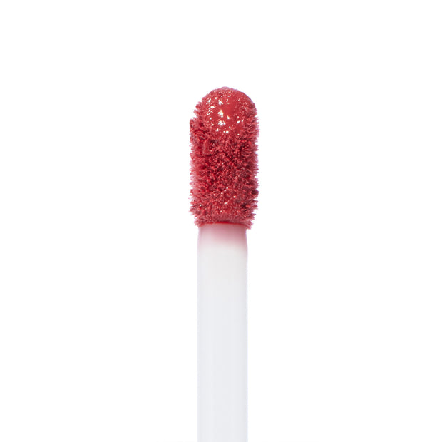 ColourPop Doozy Ultra Blotted Lip doe-foot applicator coated in warm rose, blotted pigment, captured in a sharp macro close-up against a clean white background.