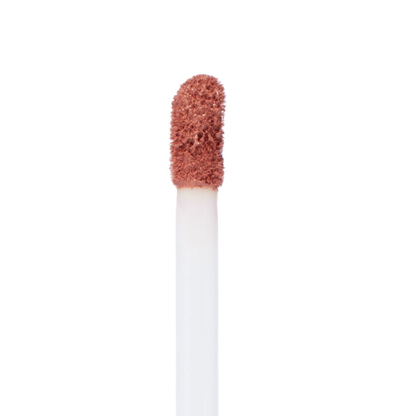 Doe-foot applicator coated in warm rosy nude Double Date shade, showcasing the velvety texture of ColourPop Ultra Matte Lip liquid lipstick in a macro close-up against a clean white background.
