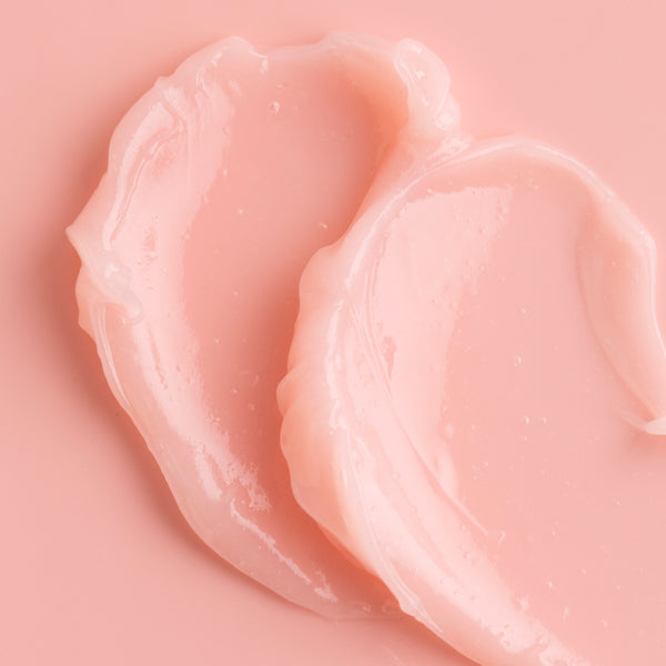 ColourPop Watermelon Lip Mask swatched in two glossy blush-pink scoops on a matching pink background, showcasing the hydrating gel-balm texture and high shine.