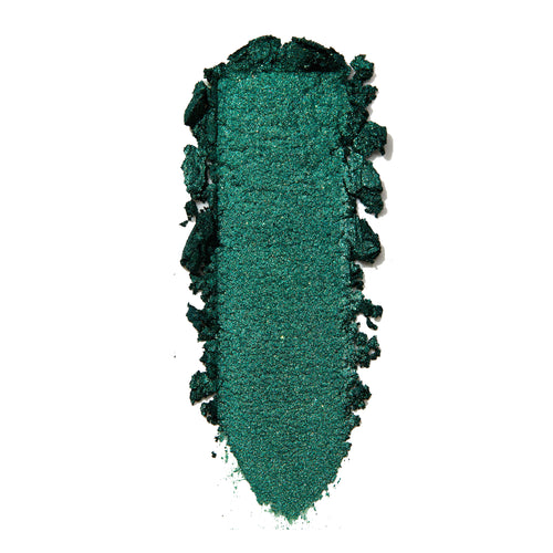 Empire Super Shock Shadow by ColourPop swatched in a single elongated smear, showing a rich metallic emerald green with fine shimmer and soft crumbled edges on a white background to highlight texture and pigment payoff.