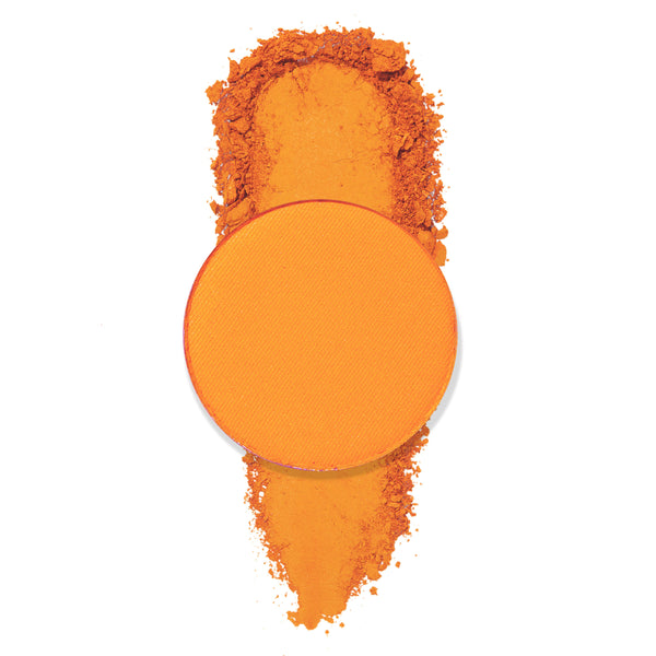 Entangled matte tangerine eyeshadow pan spills crushed pigment in a vertical swatch on a white background, highlighting the bold color payoff of the ColourPop Pressed Powder Shadow single.