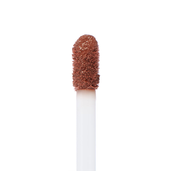 Doe-foot applicator swiped with Espresso Martini, a warm coffee-brown ColourPop Ultra Blotted Lip, showing diffused pigment and plush texture in a macro close-up on a white background.